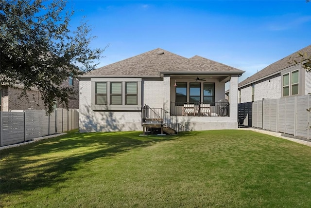 back of house featuring ceiling fan and a lawn