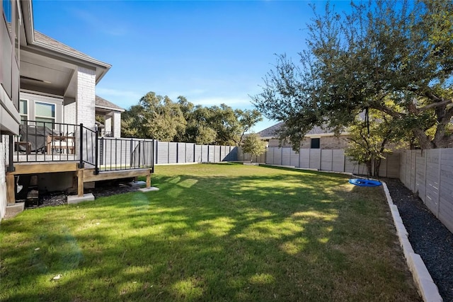 view of yard featuring a trampoline and a wooden deck