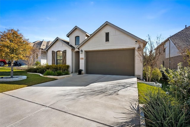 view of front of property with a front yard and a garage