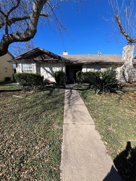 ranch-style house with a front lawn