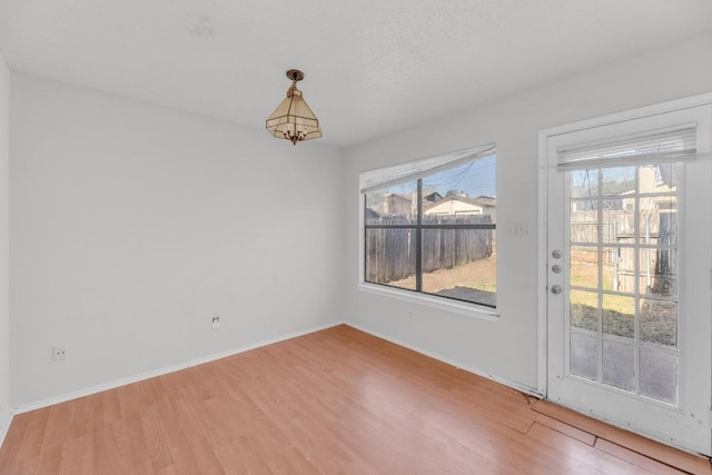 16046 Stoneham Cir, Pflugerville, TX 78660 - unfurnished room with wood finished floors, healthy amount of natural light, and baseboards