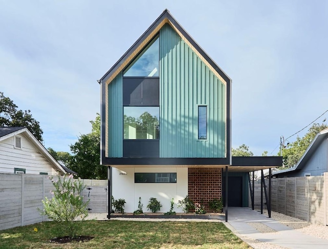 contemporary home with a front lawn