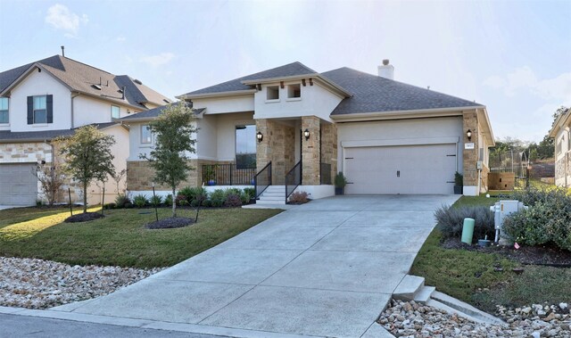 view of front of house featuring a garage and a front lawn