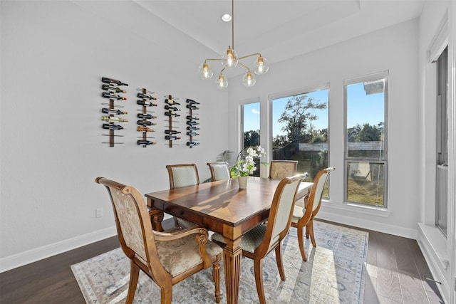 dining room featuring dark hardwood / wood-style flooring and an inviting chandelier