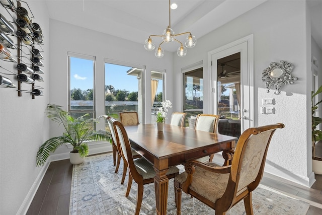 dining room with hardwood / wood-style floors and a notable chandelier