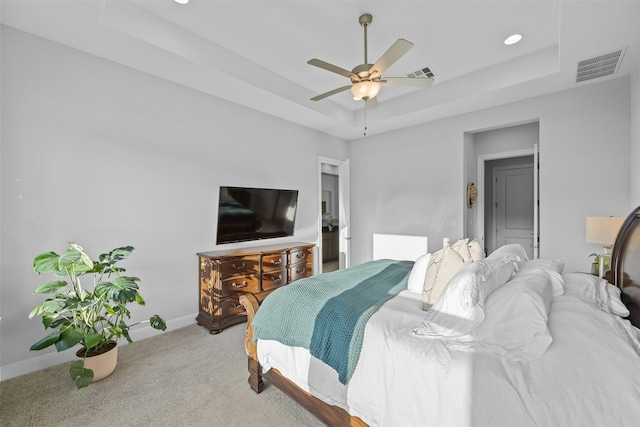 bedroom featuring carpet floors, a raised ceiling, and ceiling fan