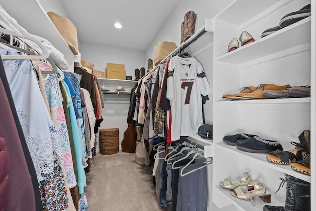 spacious closet featuring light colored carpet