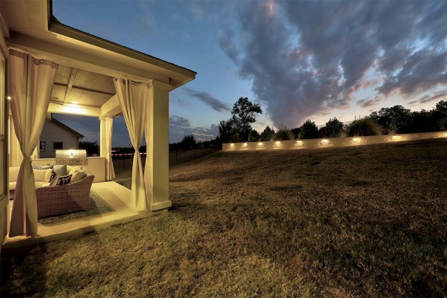 yard at dusk with an outdoor kitchen