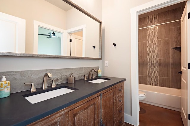 full bathroom featuring ceiling fan, toilet, vanity, and shower / tub combo with curtain