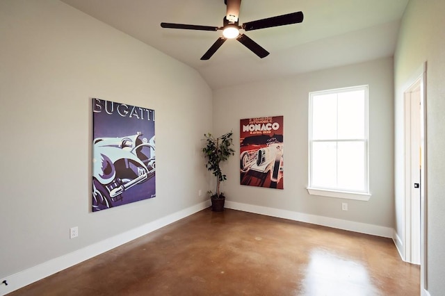 unfurnished room with ceiling fan, concrete flooring, and vaulted ceiling