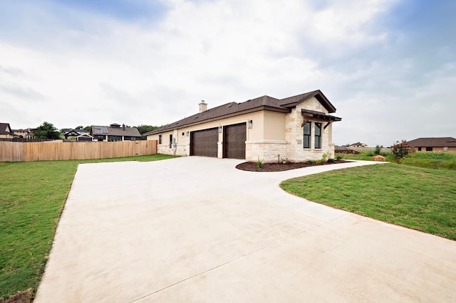 view of side of property with a yard and a garage