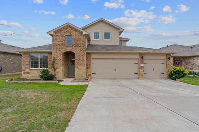 view of property with a front yard and a garage