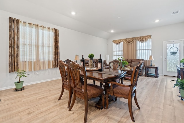 dining area featuring light hardwood / wood-style flooring and vaulted ceiling