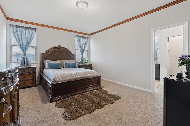 bedroom featuring light colored carpet, ornamental molding, and ensuite bathroom