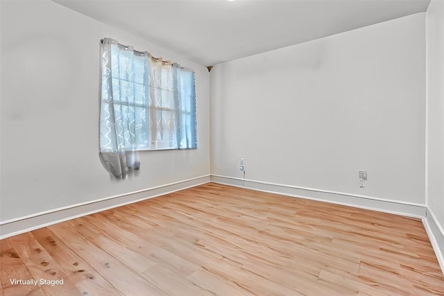 spare room featuring light wood-type flooring