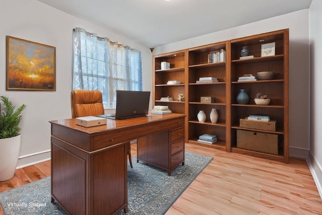 office area with light hardwood / wood-style floors