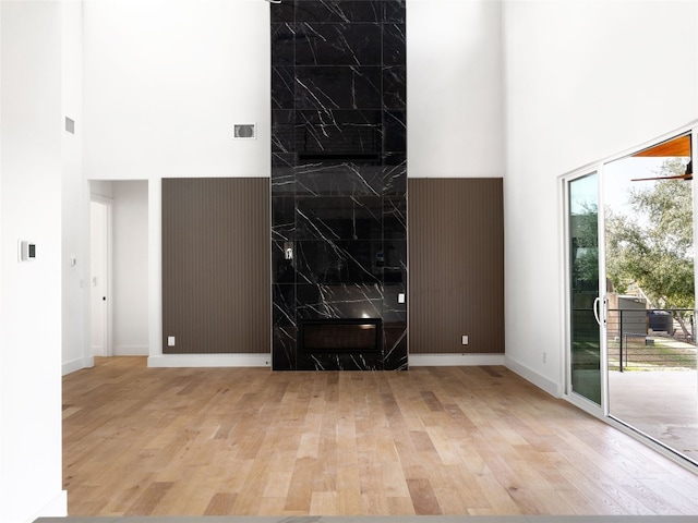 interior space featuring a high ceiling and light wood-type flooring