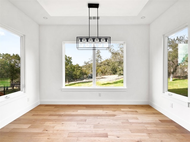 unfurnished dining area featuring light wood-type flooring