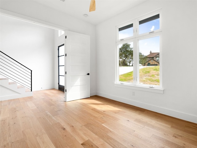 unfurnished room featuring ceiling fan and light wood-type flooring