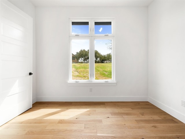 unfurnished room with light wood-type flooring