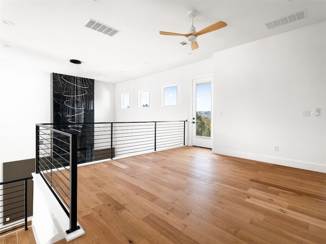 unfurnished room with ceiling fan and light hardwood / wood-style floors