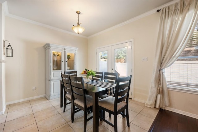 dining room with french doors, light tile patterned flooring, and ornamental molding