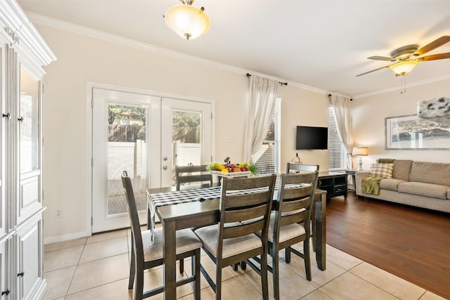 dining space featuring ceiling fan, light tile patterned floors, ornamental molding, and french doors