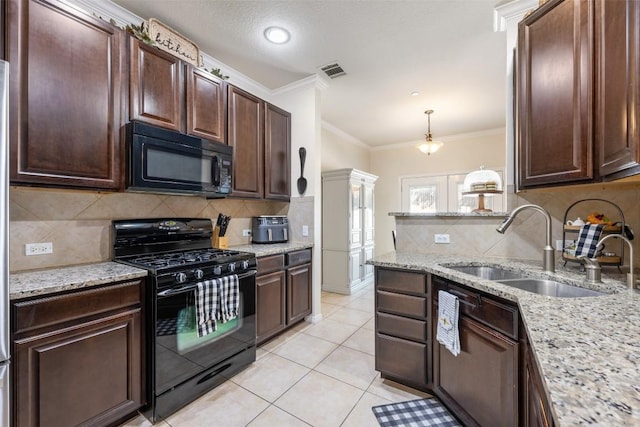 kitchen featuring pendant lighting, black appliances, crown molding, sink, and light stone counters