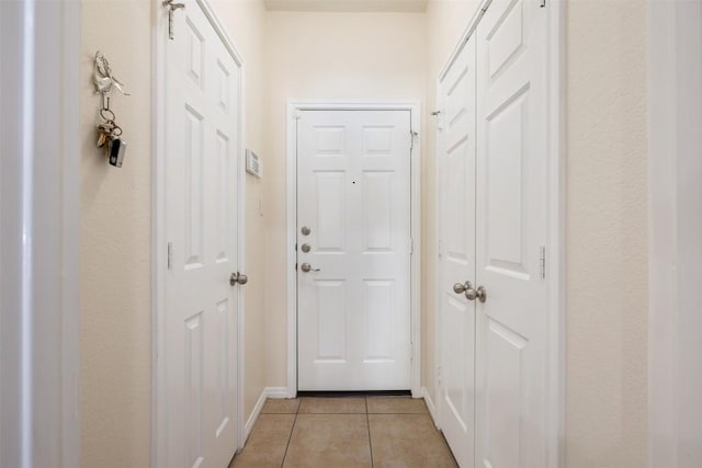 doorway to outside featuring light tile patterned flooring