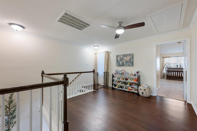 interior space featuring ceiling fan, ornamental molding, and dark wood-type flooring