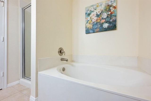 bathroom with tile patterned floors and independent shower and bath