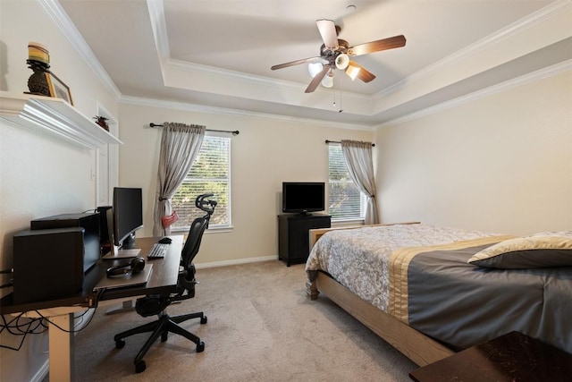 carpeted bedroom featuring ceiling fan, crown molding, and a tray ceiling