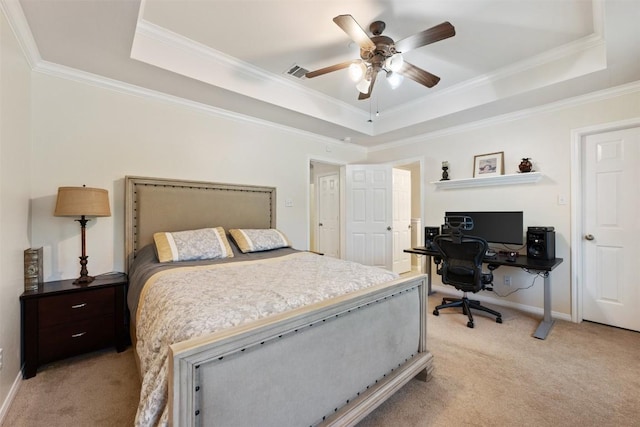 carpeted bedroom with a raised ceiling, ceiling fan, and crown molding