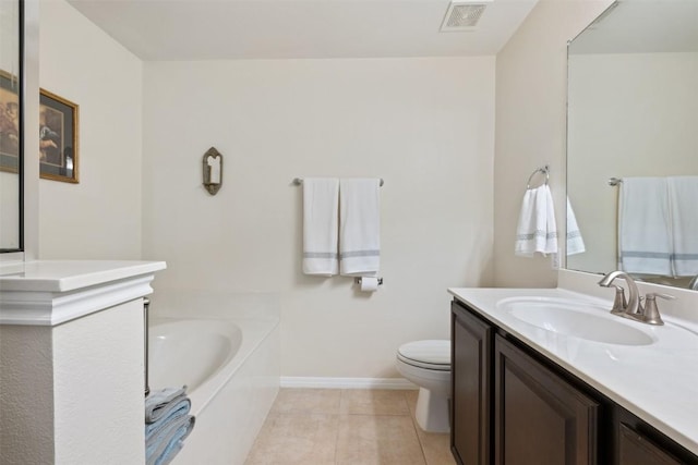 bathroom with tile patterned flooring, vanity, toilet, and a bathtub