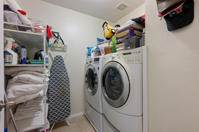 washroom with separate washer and dryer and light tile patterned floors