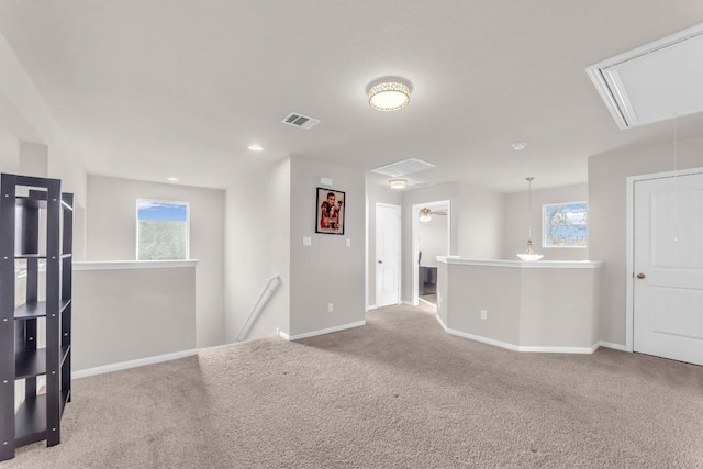 carpeted spare room featuring a wealth of natural light