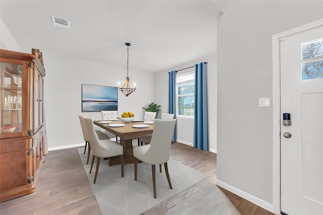 dining room with a chandelier and hardwood / wood-style flooring