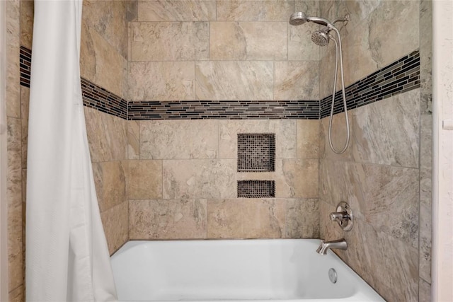 bathroom with shower / bath combo with shower curtain