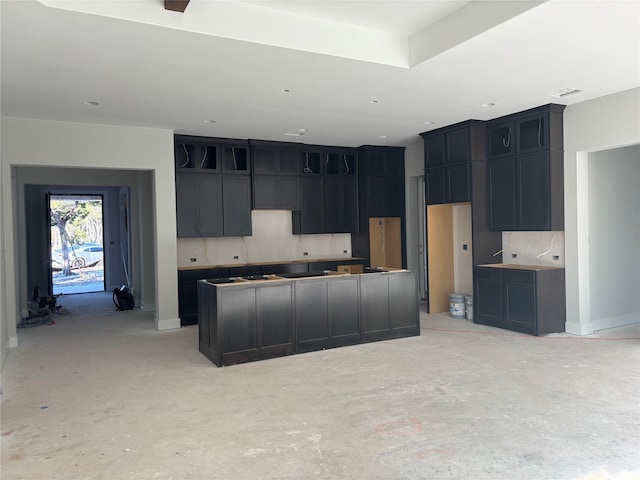 kitchen with a center island and tasteful backsplash