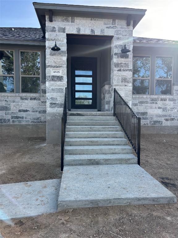 doorway to property with stone siding