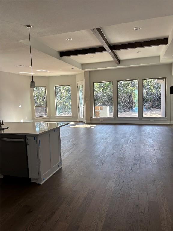 kitchen with dishwashing machine, beamed ceiling, dark wood-type flooring, and open floor plan