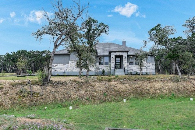 4616 Destination Way, Jonestown, TX 78645 - view of front facade featuring stone siding, a chimney, and a front yard
