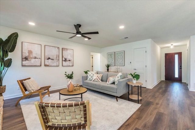 living room with ceiling fan and dark hardwood / wood-style flooring