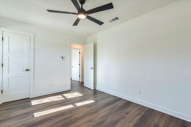 unfurnished bedroom featuring ceiling fan and dark hardwood / wood-style flooring