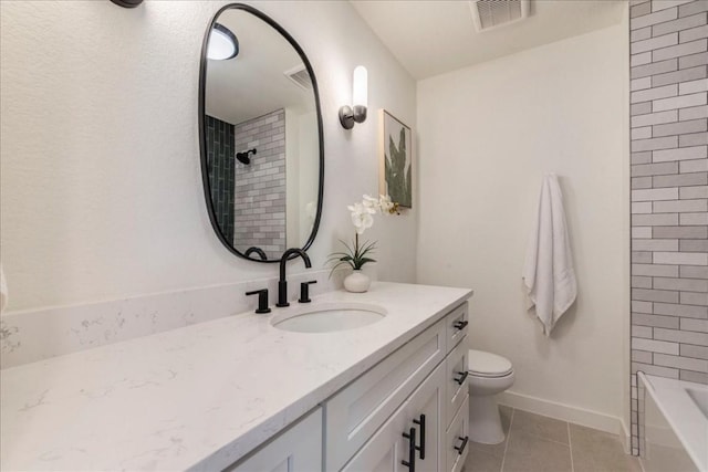 full bathroom featuring tile patterned floors, vanity, toilet, and tiled shower / bath