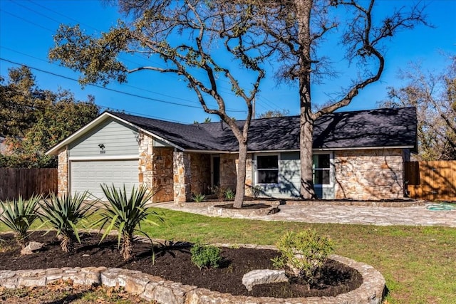 ranch-style home featuring a garage and a front lawn