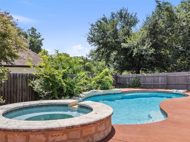 view of pool with an in ground hot tub