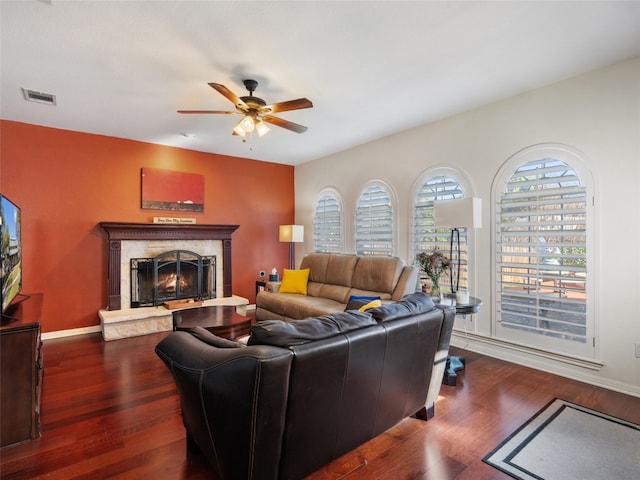 living room featuring ceiling fan and dark hardwood / wood-style flooring