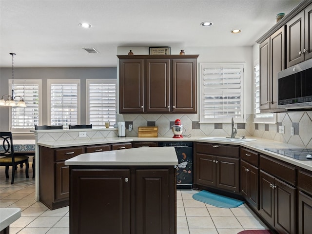 kitchen with black appliances, sink, light tile patterned floors, decorative light fixtures, and a kitchen island