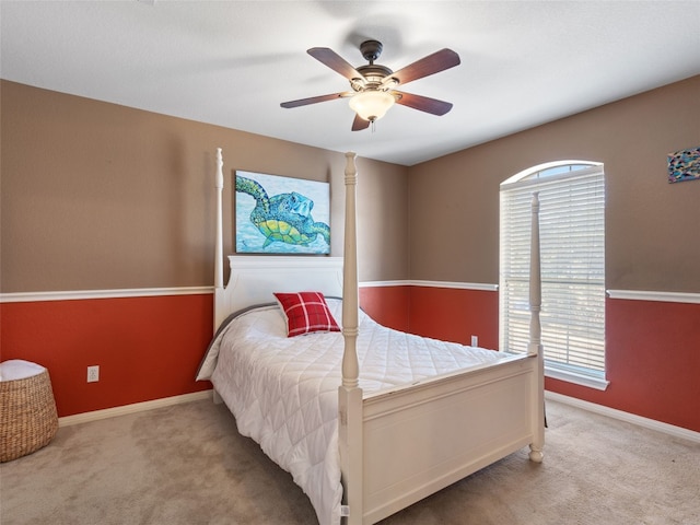 carpeted bedroom with multiple windows and ceiling fan